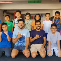 The smiles say it all. This is a group shot from one of our kids' MMA summer camps, where our "smool fighters" come together to learn, play, and grow as a team under the guidance of our expert coaches.