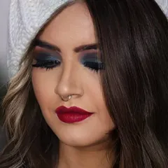 A close up of a classic smokey eye, perfect for a glamorous evening out. I used deep blue and black shades blended seamlessly, paired with a matte red lip for a timeless and sophisticated party makeup look.