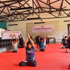 Group practice enhances the energy of our yoga sessions. Students are seen here in the Lotus Pose (Padmasana), a fundamental posture for meditation that improves concentration and cultivates inner peace.