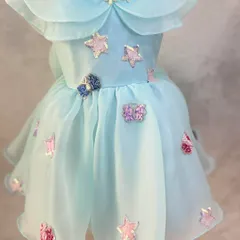 A sweet and starry custom dress. This aqua organza piece is adorned with sparkling sequin star patches and features a classic Peter Pan collar.