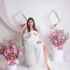 A serene seated portrait in our dreamy all-white setup. This look is so classic and truly lets the mom-to-be's glow shine through.