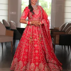 Feel like a classic bride in this radiant red lehenga. The detailed silver embroidery and perfect flare make it a timeless choice for your wedding day.