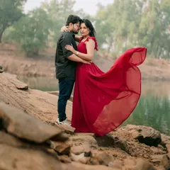 Her flowing red dress against the calm, earthy tones of the lakeside creates a stunning visual contrast. This is a moment of quiet intensity and romance from Nutan and Shubham's pre-wedding shoot in Pune.