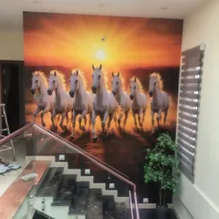 A powerful statement piece for a large wall. This custom mural of seven running horses, often associated with Vastu for success and power, was installed along a staircase. The vibrant sunset and dynamic motion create an unforgettable first impression in this home's entryway.