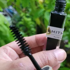 A detailed shot of the mascara wand and bottle. You can see the texture of the brush, which helps apply the natural formula smoothly.