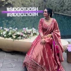 A stunning look for a wedding guest or the sister of the bride. This pink Banarasi weave lehenga features a hand-embroidered blouse and an opulent tissue drape for a touch of grandeur.