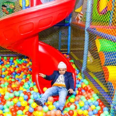 A perfect moment of fun in our colorful ball pit. It's a favorite spot for kids of all ages to play and make new friends during parties and open play sessions.