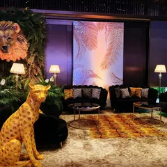 This lounge area was part of a "Walk on the Wild Side" gala. I used animal-print fabrics, a statement cheetah prop, and dramatic lighting against a custom backdrop to extend the jungle theme and create a cohesive, immersive world.
