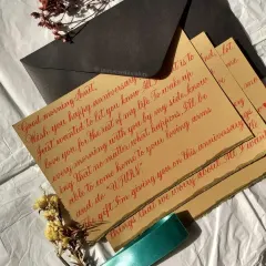 An anniversary letter is a beautiful way to capture your feelings. For this piece, I used a vibrant red ink on textured, deckled-edge paper, rolled and tied with a silk ribbon and a wax seal. It’s a complete gift, ready to be cherished.