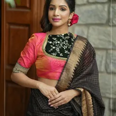 A unique blouse combining a pink silk body with a black velvet yoke, which is delicately embroidered. The cuffs also feature matching embroidery.