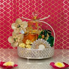 For a touch of dazzling elegance, I designed this silver crystal-top basket. It's filled with premium dry fruits, colorful potlis, and an embellished diya, making it a truly radiant Diwali gift.
