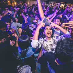A woman in the middle of the crowd, singing her heart out. This is the kind of uninhibited joy I love to see at my parties.