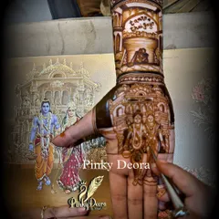 A close-up of the groom's hand, showing the Ram-Sita portrait from their wedding invite. It's a beautiful way to symbolize the foundation of their relationship.