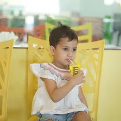 A little guest taking a juice break in our bright and cheerful cafe.