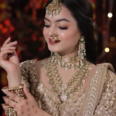 A closer look at the Diwali-themed makeup. The soft gold tones on the eyes and the beautiful pastel pink jewelry create a look that is both festive and elegant.
