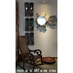 Pieces of our heart and art are found throughout our studio. A repurposed ship's porthole serves as a mirror, sharing space with a classic rocking chair and other handmade artworks that inspire us daily.