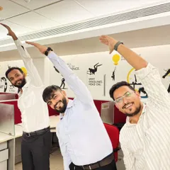 Office workers taking a moment to do a simple side-body stretch. These chair yoga exercises are perfect for releasing tension in the back and shoulders from prolonged sitting.