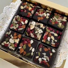 This is my fruit and nut chocolate bark, cut into squares and packed in a beautiful gift box. It's loaded with almonds, cashews, pumpkin seeds, and dried cranberries for a crunchy, chewy, and delicious bite.