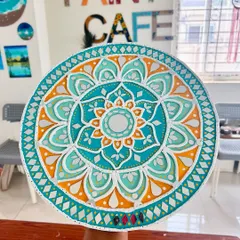 Another beautiful example of a finished Lippan art piece from a workshop, with a bright orange and teal color scheme.