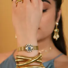 All eyes on you, but in a good way. I love this shot of a model wearing a full evil eye look, with a chunky snake bangle, a watch belt, and a stack of protective rings.