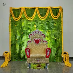 I love working with traditional elements to create something beautiful. This backdrop uses fresh banana leaves and bright yellow marigold garlands, a perfect and auspicious setup for ceremonies like a baby shower or a naming ceremony.