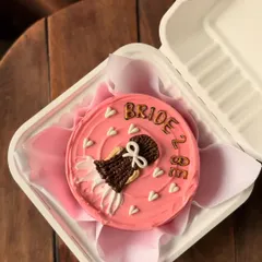 A close-up of my popular "Bride to Be" bento cake, showing the detailed piping work on the dress. It's a sweet and personal way to celebrate before the big day.