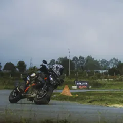 A KTM Duke 390 carving a corner with the Aruani Grid branding in the background. My track is ideal for testing the agility of street bikes.