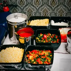 Here is a look at our pasta station ingredients, ready for a party. We use fresh corn, bell peppers, and other veggies to ensure every bowl is delicious and wholesome.