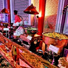 The food display is an art form in itself. Here, a vibrant and stylish buffet setup with copper and gold serveware adds a touch of glamour and makes the culinary journey a feast for the eyes as well.