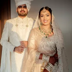A regal portrait of the bride and groom. Her glowing skin and elegant jewelry stand out against their beautiful ivory ensembles.