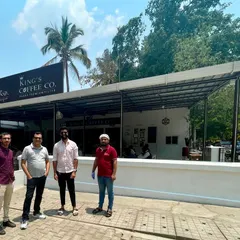 The Sparkleminds team stands with the founders outside a modern King's Coffee Co. outlet. This demonstrates the brand's evolution and our role in preparing them for the next stage of growth.