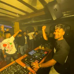 A smile on my face and a hand in the air. This is me in my element, feeding off the energy of a wild weekend crowd.