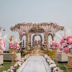 The grand mandap for Yasha and Rahil's blush-themed wedding, set against the open sea. The structure was adorned with an abundance of pink and white florals, creating a breathtaking focal point for their ceremony.
