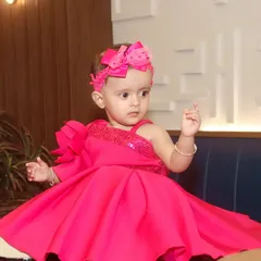 This little girl looks like a princess in her vibrant pink dress and matching bow. I love capturing kids in their finest party outfits.