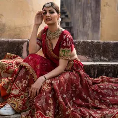 A regal pose in our classic red bridal lehenga. This is a timeless piece that will make you feel like a queen on your wedding day.