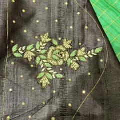 The beauty is in the details. This is a custom-embroidered Tussar silk blouse piece, featuring delicate floral work on the sleeve. It comes with a matching saree for a complete, elegant look.