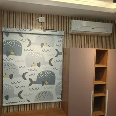 A custom-printed roller blind featuring a whale pattern, perfect for a child's room. These blinds are easy to clean and operate, making them a practical and fun choice.