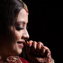 A bridal portrait is more than just a photo; it's about capturing her personality. I used dramatic lighting here to highlight the intricate details of her makeup, her gentle smile, and the quiet anticipation before the ceremony.