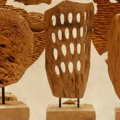 Another view of the perforated wood sculpture, showcasing the organic shape and the intricate, hand-carved details that make each artifact one-of-a-kind.