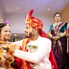 The groom ties the sacred 'mangalsutra' around the bride's neck, a pivotal moment in a Maharashtrian wedding ceremony.