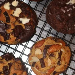 A selection of our chunky, freshly baked NY-style cookies. We offer a variety of flavors, from classic chocolate chunk to almond oats and vanilla coffee.