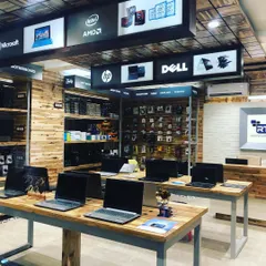 In the RT Computers showroom, we created an industrial-chic vibe with exposed wood paneling and simple metal-frame tables. The overhead brand signage is backlit and clearly organized, making it easy for customers to navigate the store.