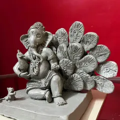 Another angle of the peacock feather Ganesha, showing the depth and arrangement of the feathers. Each commissioned idol is a unique piece of devotional art.