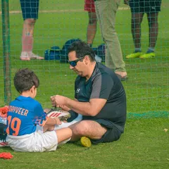 Sport is a family affair. I love seeing moments like this, where a father helps his son get ready for the big game, showcasing the supportive community we foster.