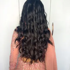 A back view showing the beautiful, natural-looking soft curls I created for this client. The style is effortless and chic.