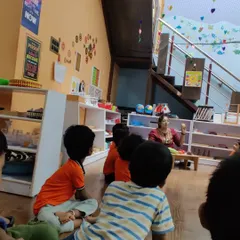 A group discussion about vegetables. We use real objects whenever possible to make learning concrete. The children are engaged, asking questions, and sharing their own knowledge in this interactive session.