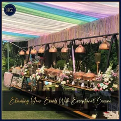 A colorful and festive outdoor buffet setup under a rainbow-hued canopy. This image shows our ability to match our setups to any wedding theme, from elegant and classic to bright and celebratory.