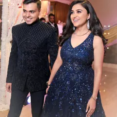 A candid moment of happiness during an engagement ceremony. We focus on capturing the natural chemistry between a couple, like this shot of them entering the venue, hand-in-hand, with genuine smiles.