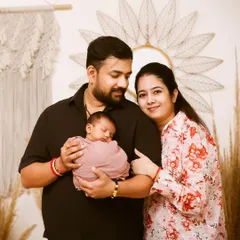 The first family portrait. This photo captures the pride and love of new parents as they hold their sleeping newborn, creating a beautiful memory of the day your family grew.