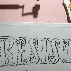 A close-up of the line art for the word "Resist," showing the clean, decorative swirls and consistent thickness of the hand-drawn letters.